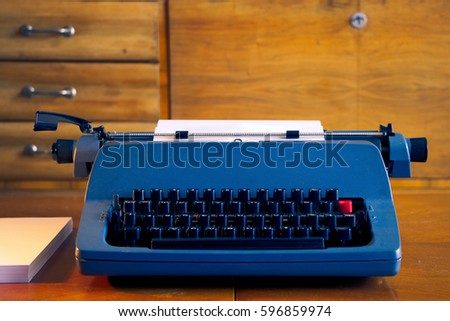 old blue retro typewriter in a antique wooden room, writing letter, journalistic tool 
