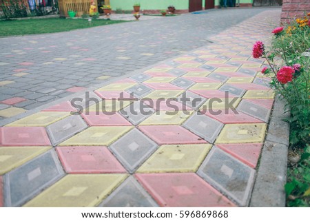Pavers colored inserted on the courtyard, stone tiles neat