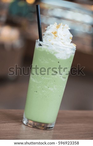 Iced green tea smoothie on table