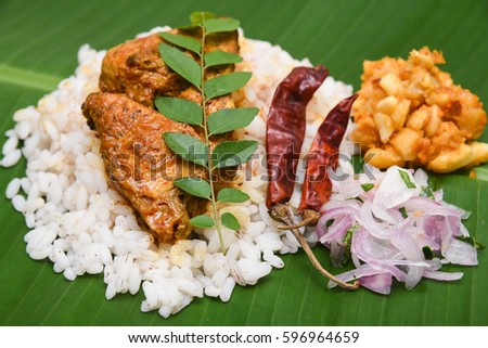 Very popular Kerala fish curry with white rice in coastal area south Indian and Sri Lanka, Malaysia, Thailand, Singapore. made by marinated mackerel fish with Indian spices. sea food green banana leaf