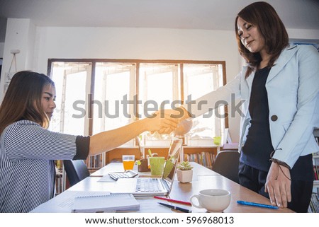 Businessmen shaking hands during a meeting.