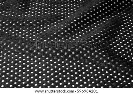texture, background, pattern. black leather cloth. Punched round holes in the fabric
