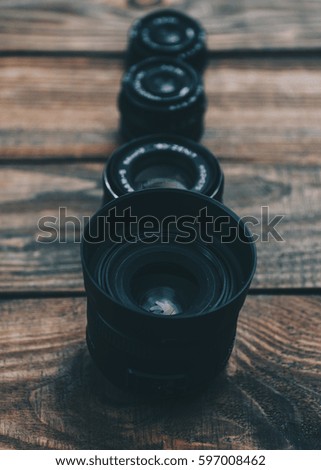 Lens on the wooden table for dslr camera