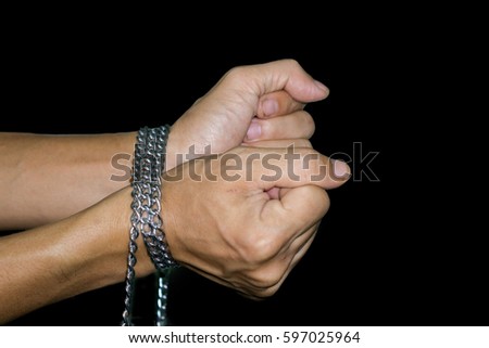 Arms tied with chains Isolated black background