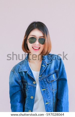 Closeup Asian woman casual outfits standing in jeans and blue denim shirt, women brown hair and short, smiling and wearing sunglasses, beauty and fashion concept, Jeans concept