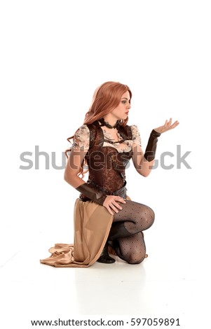 full length portrait of a beautiful girl wearing steampunk outfit, seated pose isolated on white background.