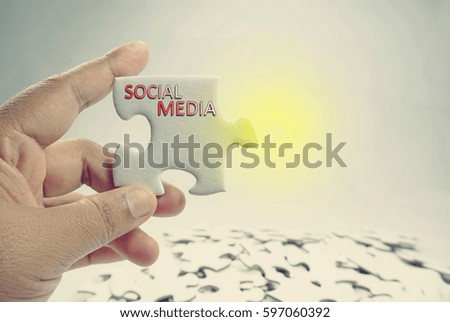Business and finance concept – female hand holding a piece of puzzle.