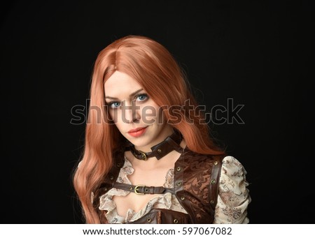 close up portrait of a beautiful girl wearing steampunk outfit, isolated on black background.