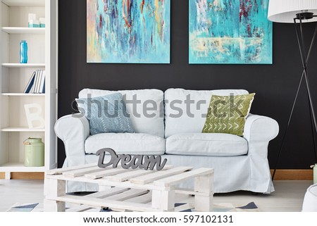 White couch in the room with patterned carpet