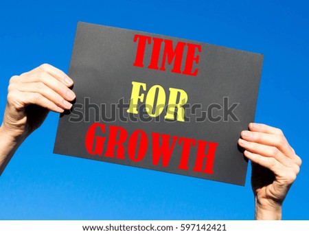 Black card placard with the concept of Time For Growth against a clear blue sky background