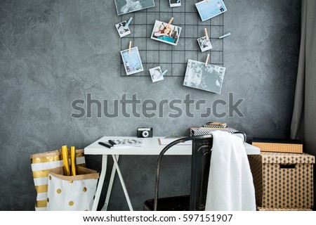 Home workspace with grey wall, table and chair