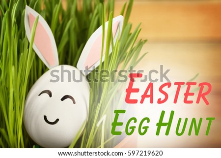 Easter hunt concept. Decorated egg in green grass, closeup