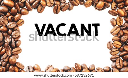 A copy space coffee concept  top view rich roasted coffee beans over a white background with a word VACANT