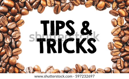 A copy space coffee concept  top view rich roasted coffee beans over a white background with a word TIPS & TRICKS