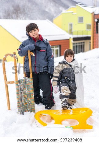 Child playing and having fun at winter snow