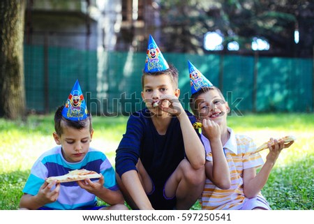 Kids having a birthday party at the park. 