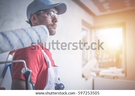 Room Painting Job. Caucasian Room Painter with Painting Roller. Royalty-Free Stock Photo #597253505