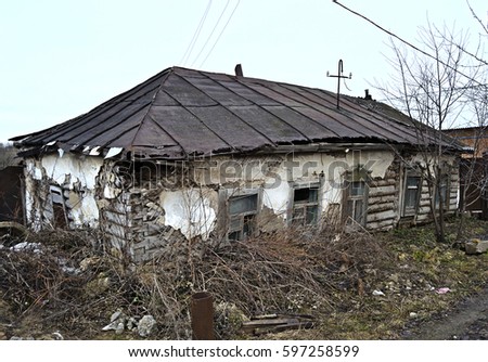 View of an old abandoned log house, finished with plaster in a Russian village. . Destroyed and abandoned house. Mystical House. Not far from Tula. Russia