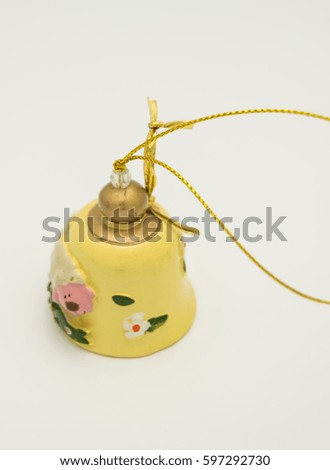ceramic yellow bell ornament with a sheep and flowers with golden ribbon