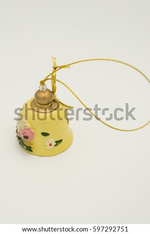 ceramic yellow bell ornament with a sheep and flowers with golden ribbon