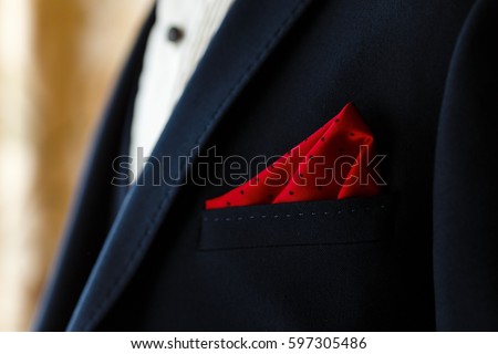 Young groom in dark blue suit with red dotted handkerchief in the pocket. Men's wedding accessories Royalty-Free Stock Photo #597305486