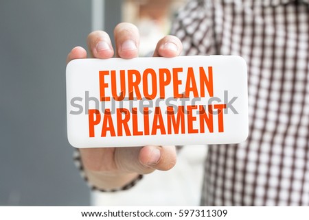 Man hand showing EUROPEAN PARLIAMENT word phone with  blur business man wearing plaid shirt.