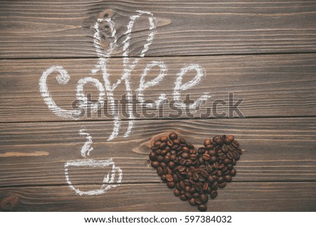 Heart made of coffee beans and a drawn cup