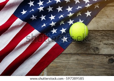 tennis ball with an American flag on wood table