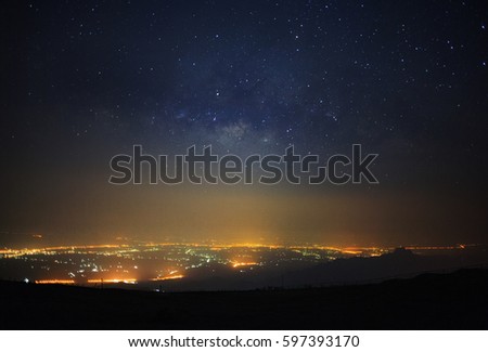 Milky way galaxy and city light at Phutabberk Phetchabun in Thailand.Long exposure photograph.