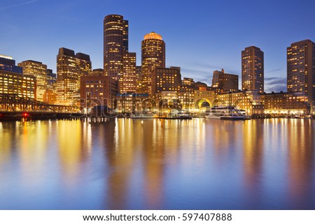 The skyline of downtown Boston, Massachusetts from across the water at dusk.