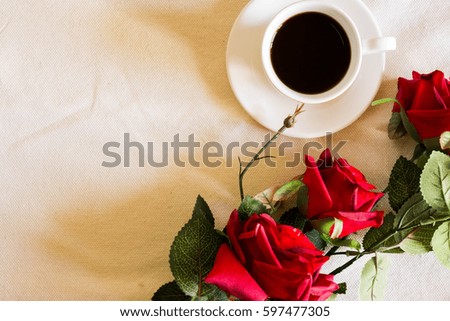 Roses and coffee on a white sacking. Greeting card.