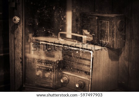 dusty old radio on a wooden table ,still life style