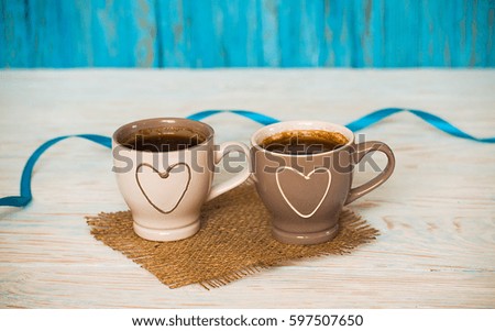 Cooked black coffee with sweet marshmallow on a blue wooden table