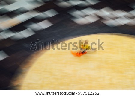 Blurred Abstract Background. Child on the scooter moves quickly in a public building hall top view. Motion blur technique of low speed shot. Blur silhouette of child. Low speed shutter shot.