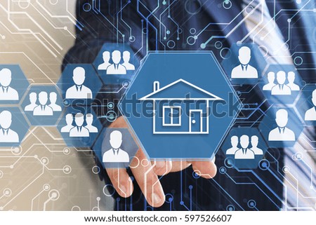 The businessman clicks with web touch home on the touch screen with a futuristic background .The concept of finding housing for rent or purchase. 
