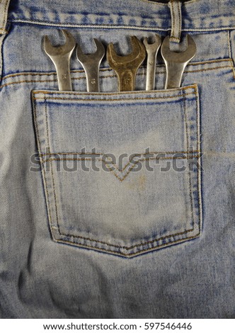Wrench tools in the blue pocket jeans