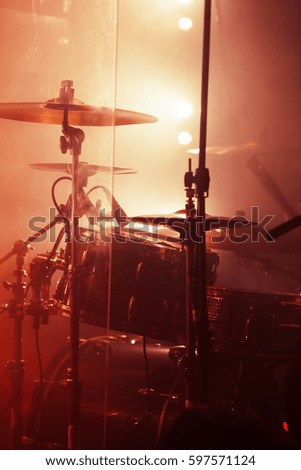 Live rock music background, rock drum set. Warm toned closeup vertical photo, soft selective focus