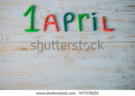 April Fools' Day text made with plasticine on white wooden background