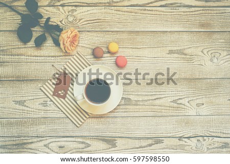 Macaroons on the wooden coffee desk in vintage color tone.