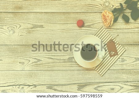 Macaroons on a wooden table with cup of coffee.