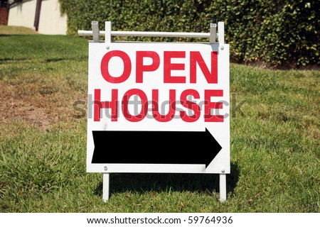 Real estate open house sign in a yard