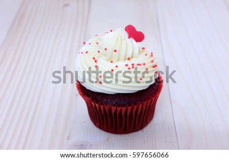 The red velvet cup cake on a wooden background 