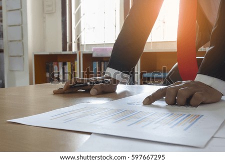 businessman working and analyzing financial reports in office.