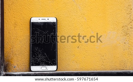 Touch screen mobile smartphone with broken screen  isolated on background.