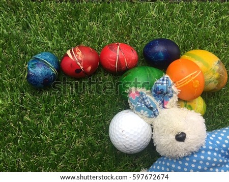 Golf Easter Holiday with Rabbit and golf ball with Easter eggs on green grass