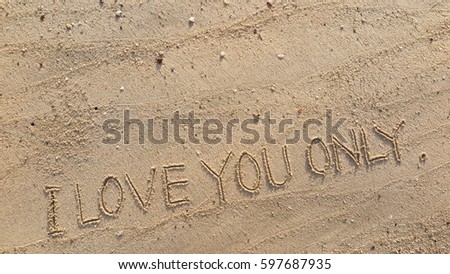 Handwriting words "I LOVE YOU ONLY." on sand of beach