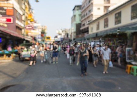 blur background of tourist walking in Khao San road in afternoon. Khao San road is famous tourist hub in bangkok, Thailand