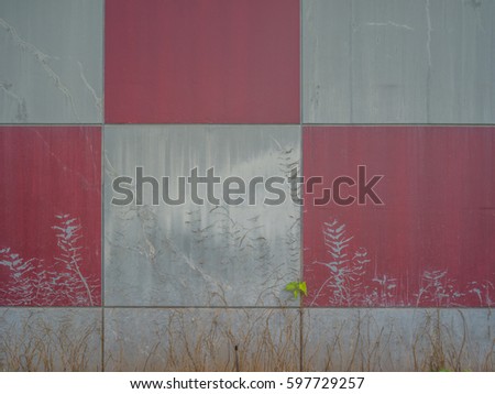 Silver, red and gray panels on an exterior wall.