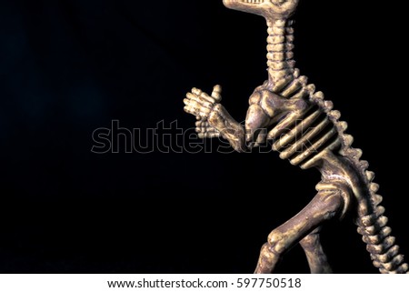 Isolated dinosaur on black background with copy space for texting. Dark tone picture style.