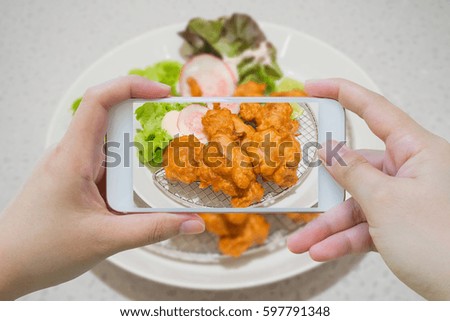 taking photo of fried chicken Japanese style with smartphone